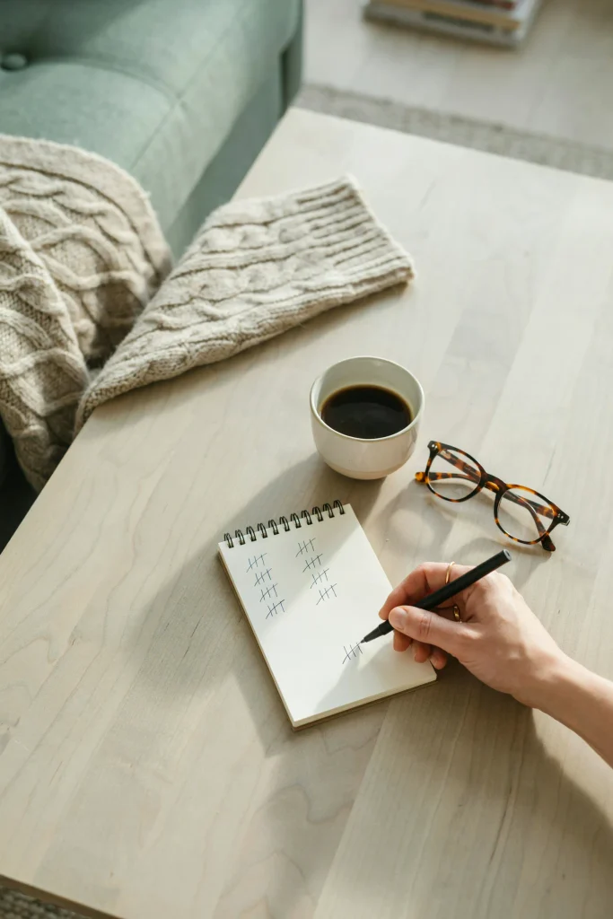 Woman holding pen writing tally