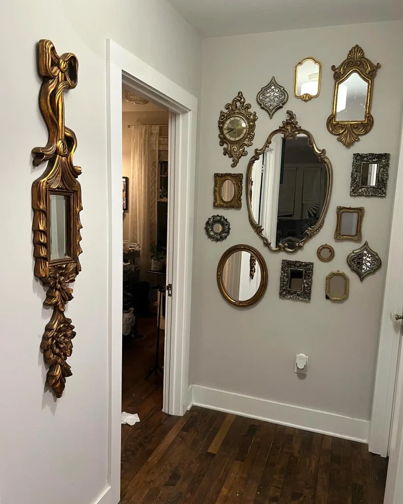 a Dark Hallway With a Cluster of Ornate Gold Mirrors
